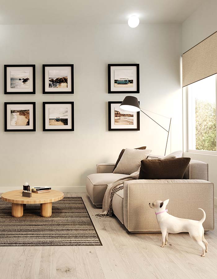 A rendering of a living room with artwork, a sofa and a wood coffee table.