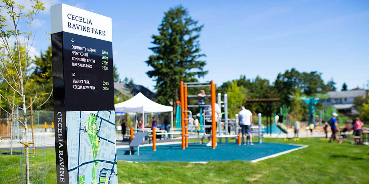 Cecelia Park with grass, trees and a kids playground.