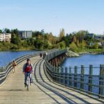 A person biking on the galloping goose trail in Victoria, BC.