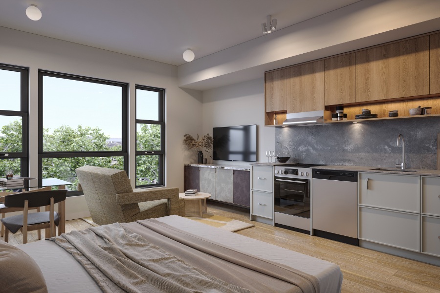 A rendering of a residential home at Tresah East, including a bed, chair, tv, and kitchen space.